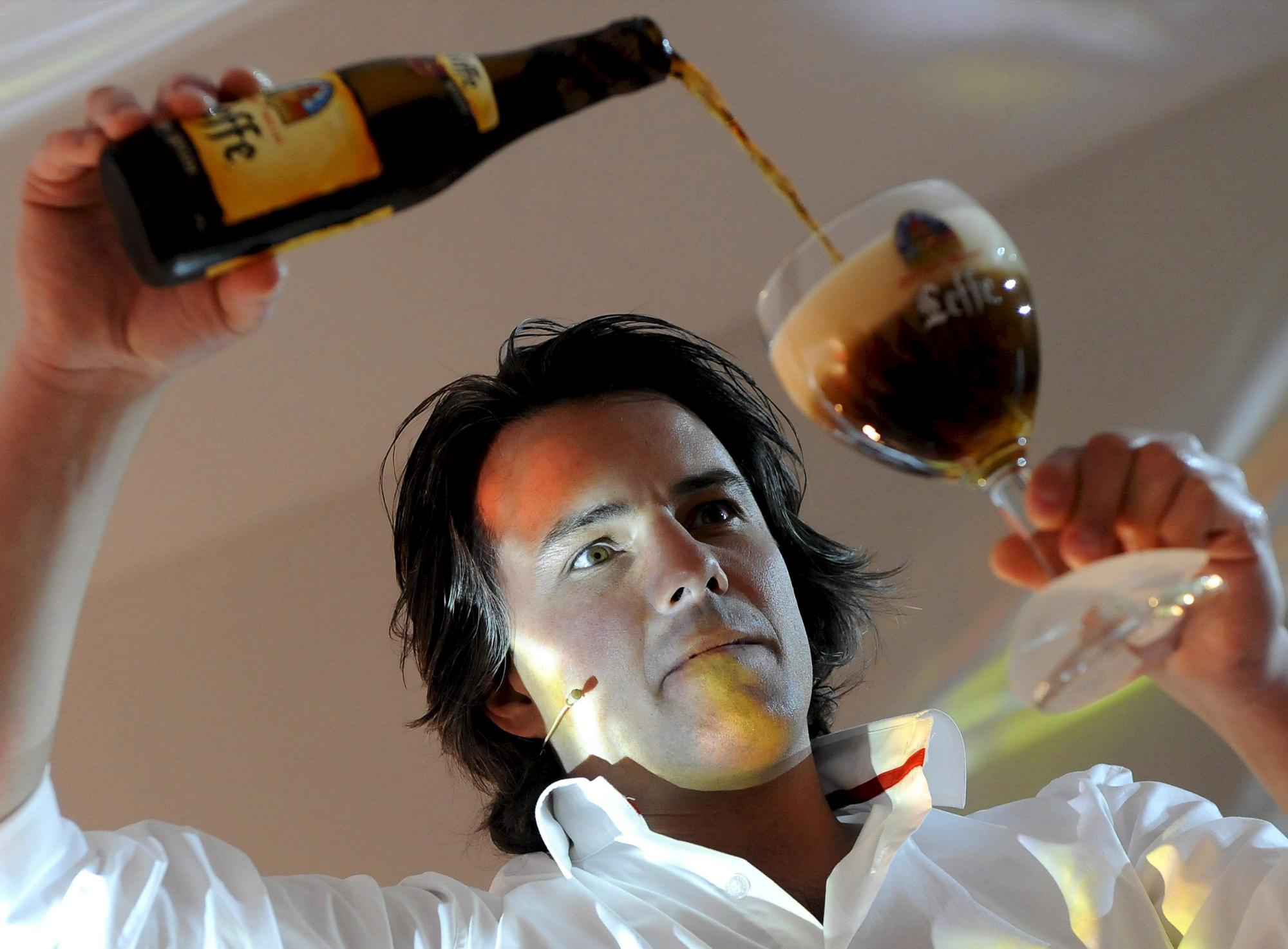 El camarero belga Tom Tommy Goukens sirve una cerveza de la marca Leffe durante el campeonato mundial Stella Artois, que premia a los mejores tiradores de cerveza del planeta, en Leuven, Bélgica