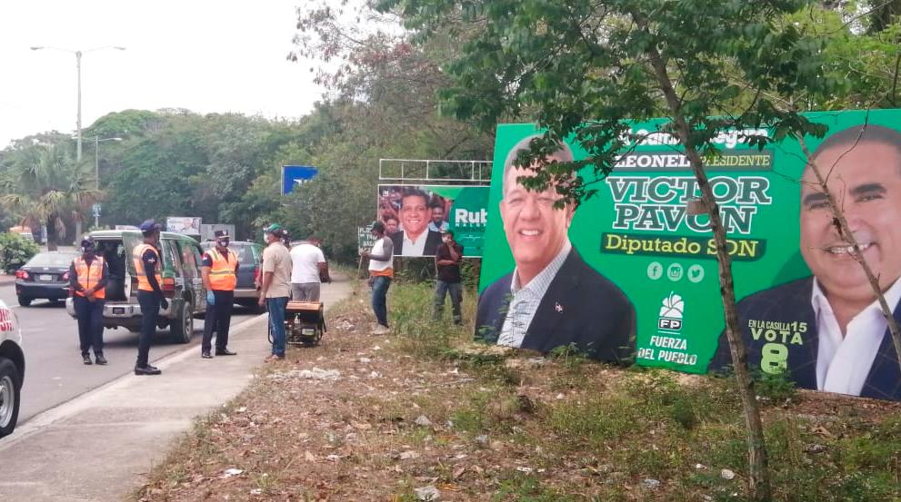 Foto suministrada por el candidato, cuando, supuestamente, Obras Públicas les retiraba una propaganda de la vía. 