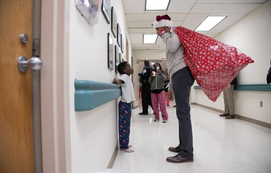 Obama entrega regalos a niños enfermos vestido de Papá Noel