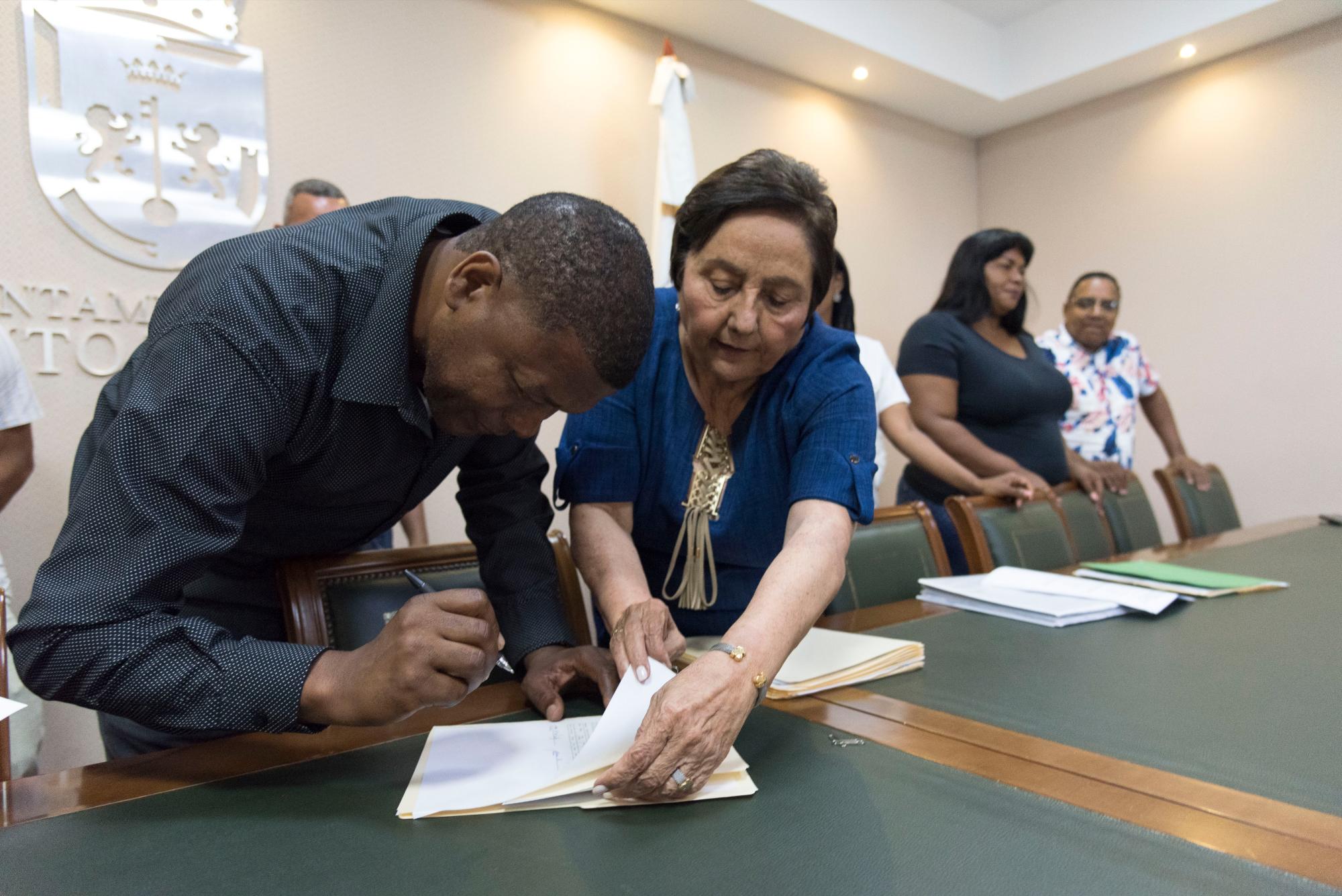 Buhoneros reciben de la tesorera del cabildo, Pastora Méndez, los viáticos del viaje. (Pedro Bazil)