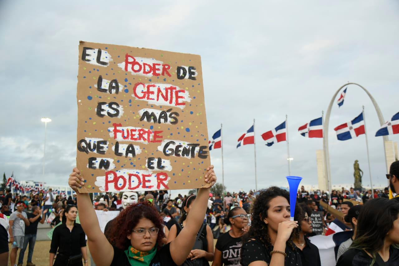 Una joven levanta su pancarta durante la manifestación de este sábado a la Plaza de la Bandera.