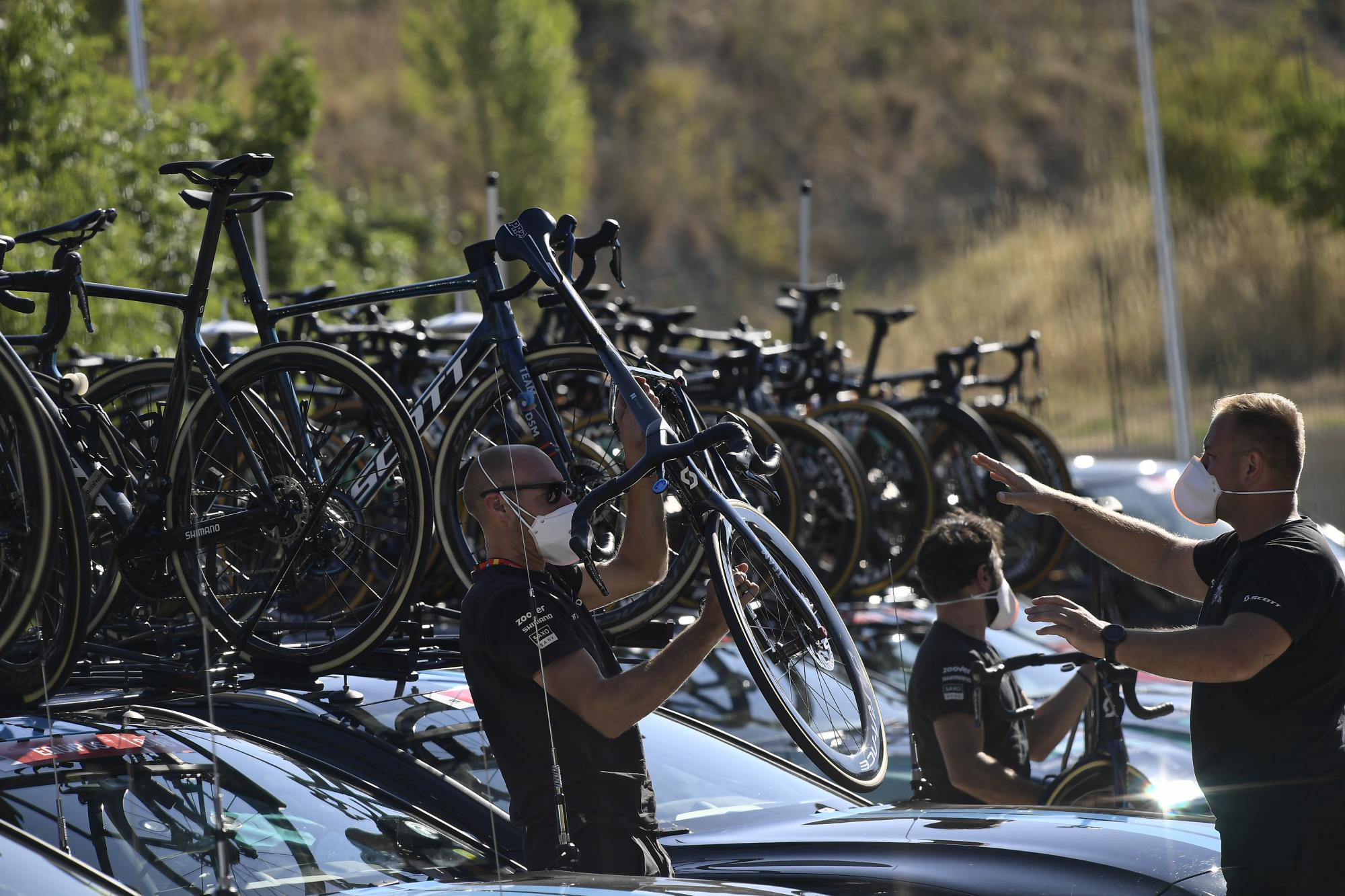 El personal de la Vuelta a España alista las bicicletas previo al comienzo de la tercera etapa en Santo Domingo de Silos, el lunes 16 de agosto de 2021. (AP Foto/Alvaro Barrientos)