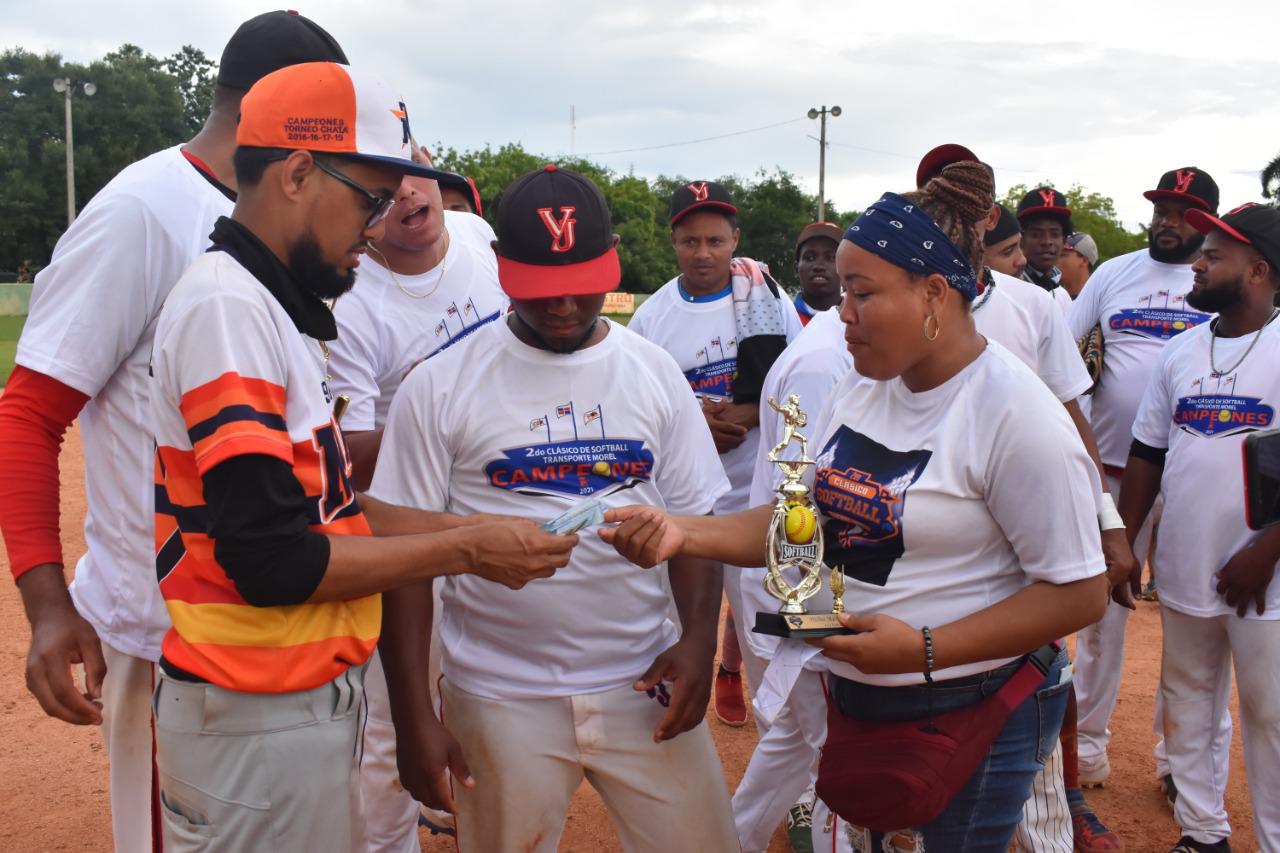 El lanzador José Báez, centro, premiado por María Estela y Jhohansel Bautista con RD$10 mil y un trofeo por su actuación en el torneo Transporte Morel. (Fuente externa)