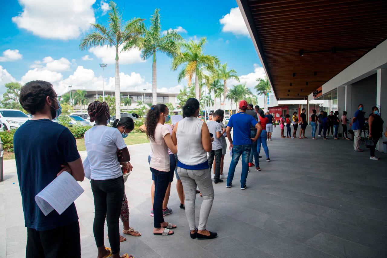 Fila de persona para aplicarse primera, segunda y tercera dosis de COVID-19