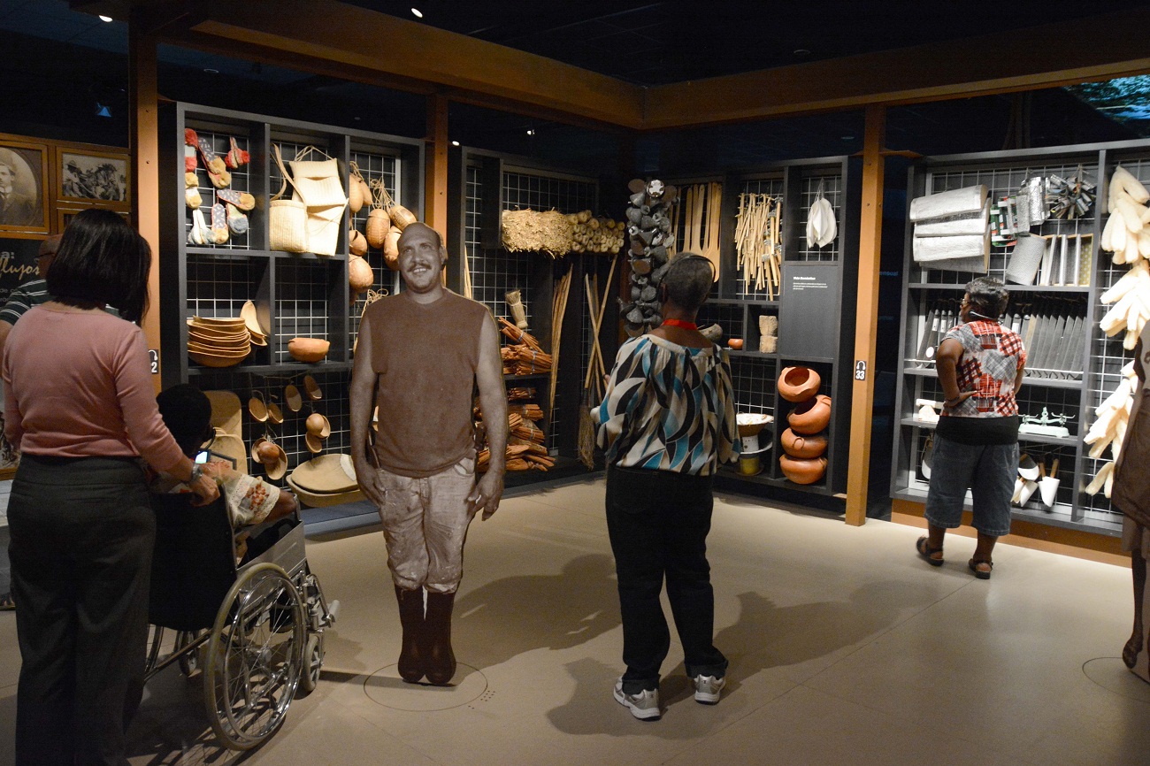 Fotografía cedida por el Centro León que muestra a turistas viendo las exposiciones sobre elementos típicos de Santiago.