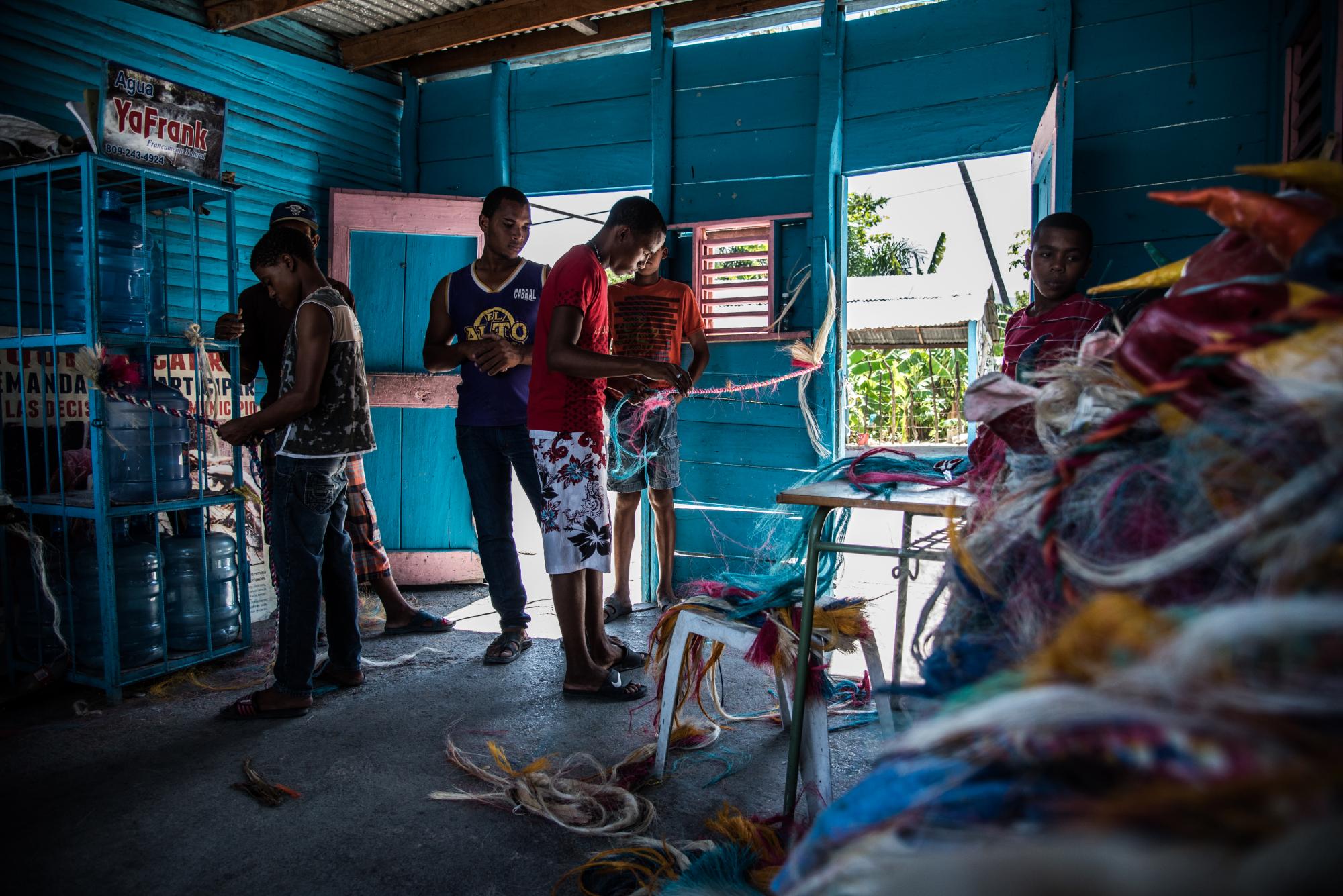 Jóvenes trabajan en la elaboración de fuetes. 