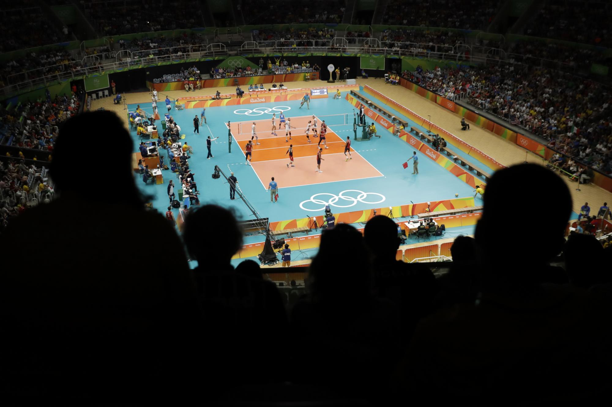 Aficionados observan un encuentro preliminar de voleibol masculino entre Italia y los Estados Unidos.