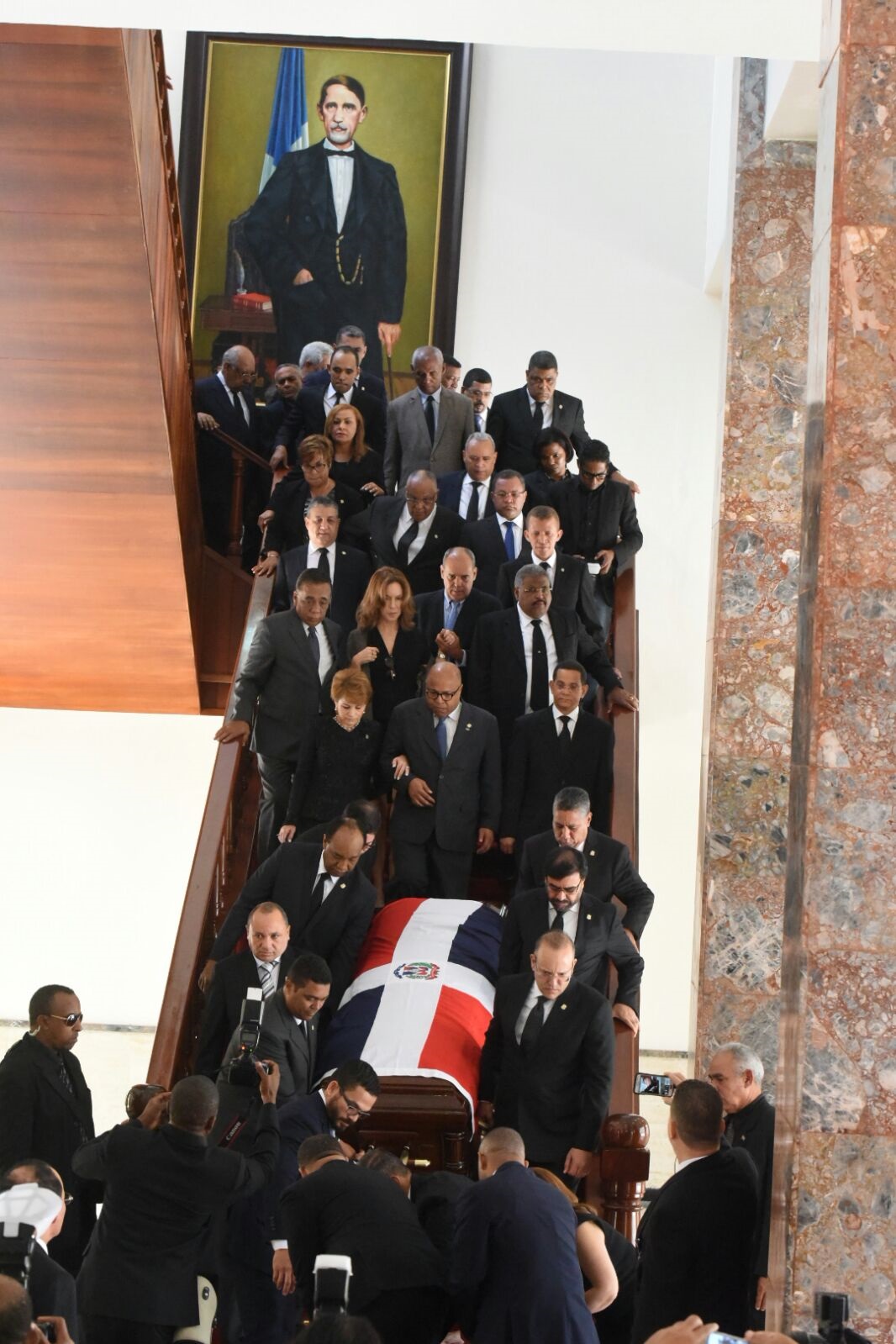 El féretro con los restos de Hatuey De Camps es bajado por las escaleras del Congreso Nacional 