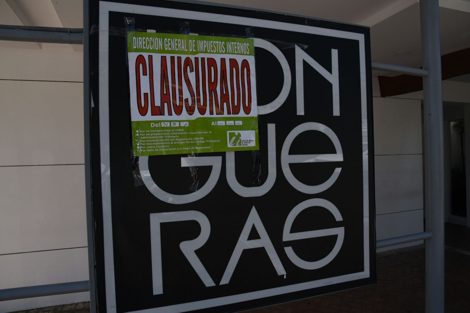 Letrero colocado por la DGII sobre el logotipo del salón Llogueras