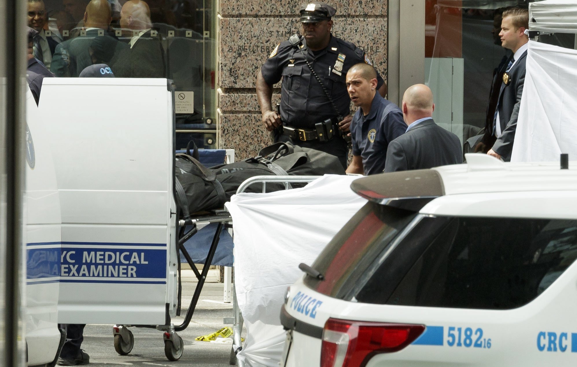 Trabajadores de la Oficina Médica de la Ciudad de Nueva York retiran el cuerpo de una fallecida después de que un vehículo impactara a varios peatones.