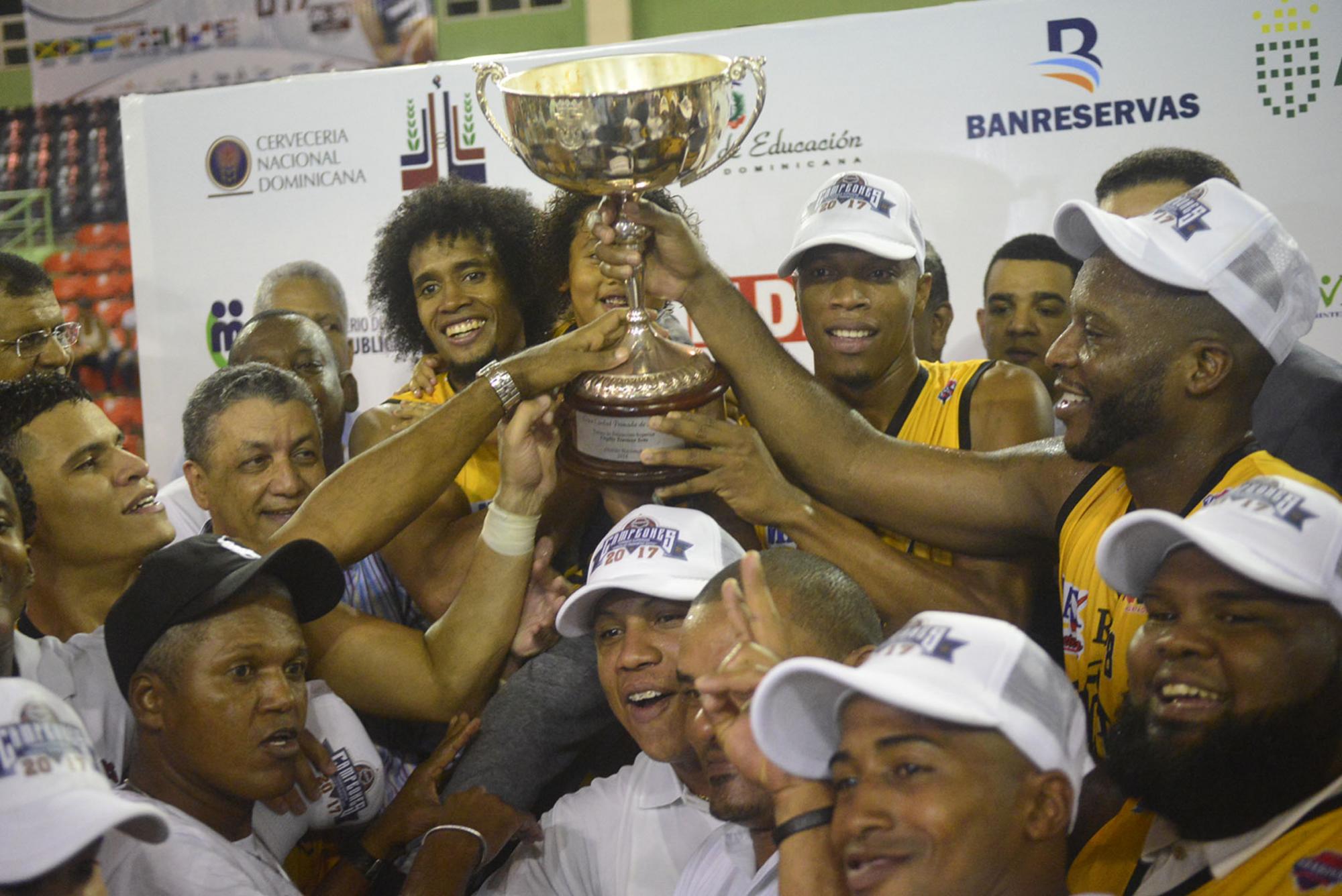 Jugadores y seguidores del Barias levantan la copa de campeón.