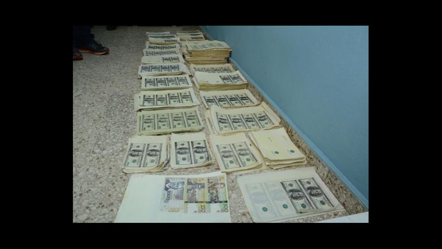 Ocupan más de cinco millones de dólares falsos durante allanamiento en residencia de Santo Domingo Este
